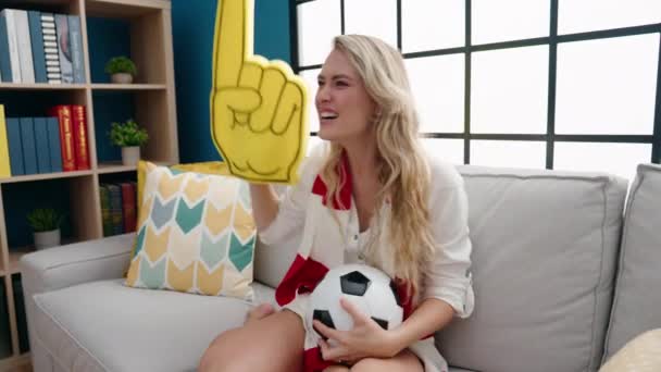 Young Blonde Woman Supporting Soccer Team Sitting Sofa Home — Vídeos de Stock