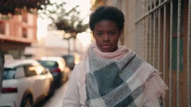 Young african american woman photographer using professional camera at street