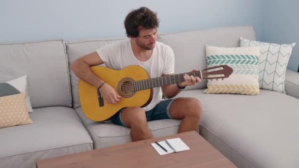 Young Hispanic Man Playing Classical Guitar Composing Song Home — Stockvideo