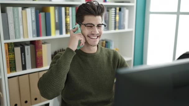 Young Hispanic Man Student Talking Smartphone Using Computer Library University — Video Stock