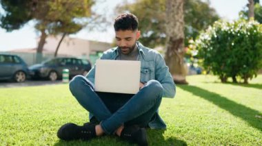 Young arab man smiling confident using laptop at park