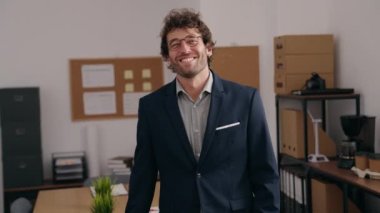 Young hispanic man business worker smiling confident standing at office