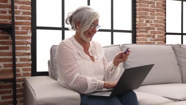 Middle Age Grey Haired Woman Smiling Confident Paying Using Laptop — Stockvideo
