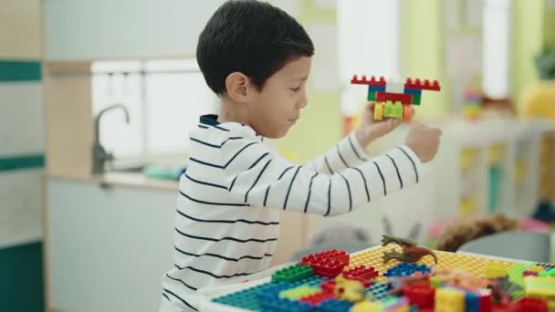Adorable Hispanic Boy Playing Construction Blocks Sitting Table Kindergarten — Stock video