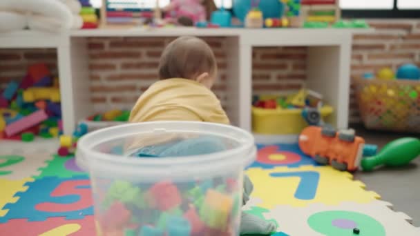 Adorable Hispanic Baby Putting Car Toy Cube Sitting Floor Kindergarten — Stock Video