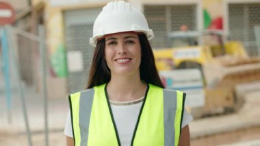 Young beautiful hispanic woman architect smiling confident standing at street