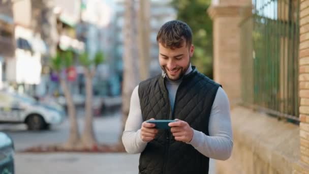 Young Hispanic Man Smiling Confident Playing Video Game Street — Stock Video