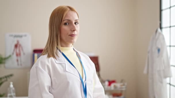 Young Blonde Woman Doctor Smiling Confident Holding Stethoscope Clinic — Stock Video