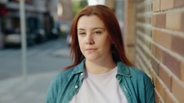 Young beautiful plus size woman smiling confident standing at street