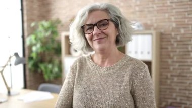 Middle age woman with grey hair business worker smiling confident at office