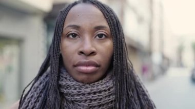 African woman smiling confident at street