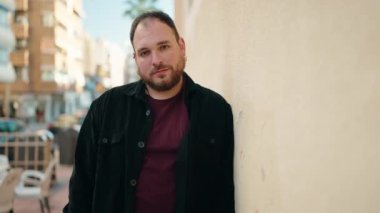 Young plus size man smiling confident standing at street