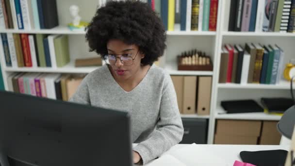 African American Woman Student Using Computer Writing Notebook Library University — 图库视频影像