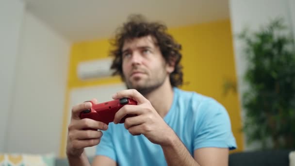 Young Hispanic Man Playing Video Game Sitting Sofa Home — Vídeo de stock