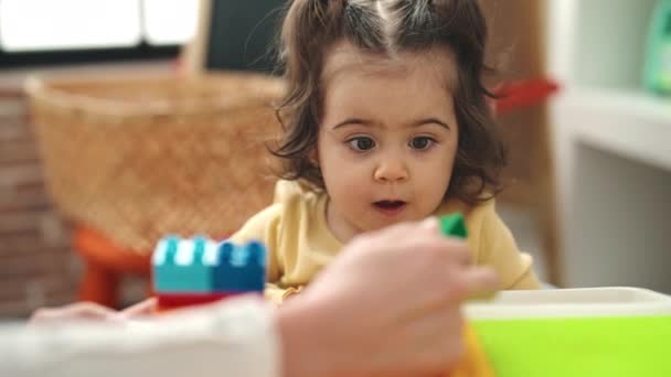 Adorable Hispanic Girl Playing Construction Blocks Standing Kindergarten — Vídeos de Stock