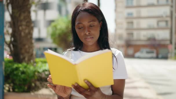 Młoda Afroamerykanka Czyta Książkę Parku — Wideo stockowe