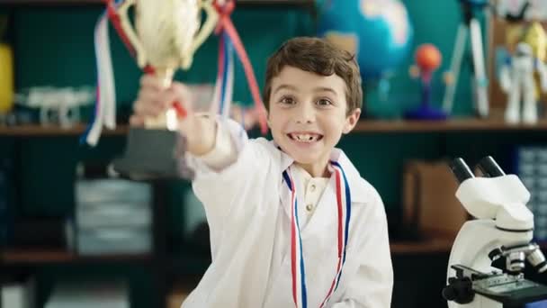 Adorable Hispanic Boy Student Smiling Confident Holding Trophy Laboratory Classroom — Stockvideo
