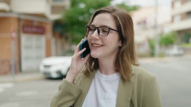 Young woman business worker talking on smartphone at street
