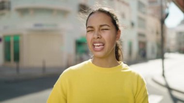 Young african american woman smiling confident speaking at street