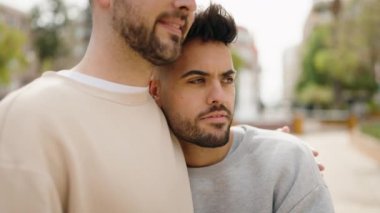 Young couple smiling confident hugging each other at park