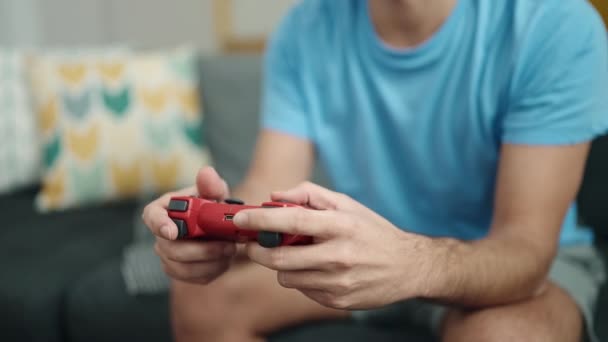 Young Hispanic Man Playing Video Game Sitting Sofa Home — Vídeo de Stock