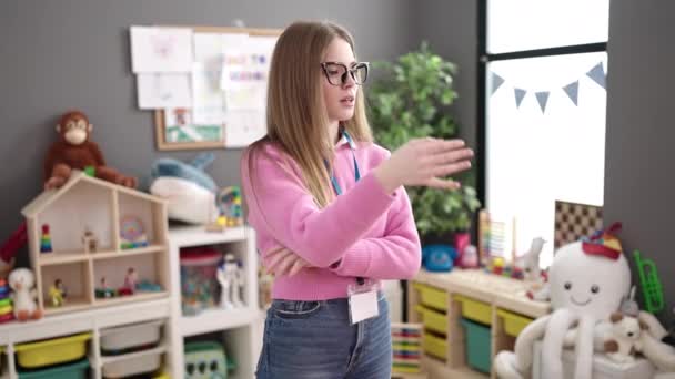 Young Blonde Woman Preschool Teacher Asking Silence Kindergarten — Stockvideo