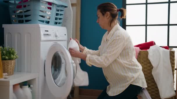 Middle Age Woman Smelling Towel Washing Clothes Laundry Room — Videoclip de stoc