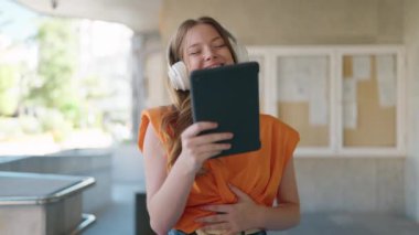 Young woman smiling confident watching video on touchpad at university