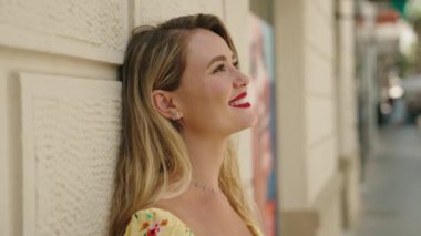 Young beautiful hispanic woman smiling confident looking to the side at street