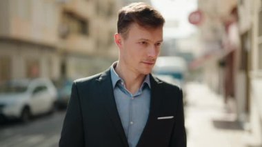 Young caucasian man smiling confident standing at street