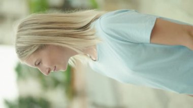 Sokakta kendine güvenen genç sarışın kadın gülümsüyor