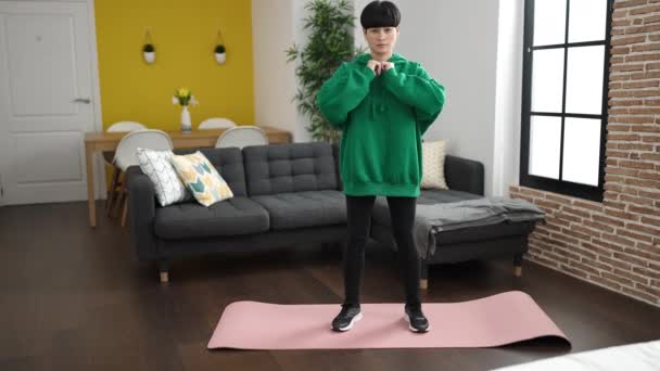 Young Chinese Woman Training Legs Exercise Standing Home — Stockvideo