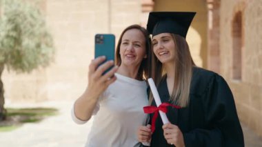 Two women mother and graduated daughter having video call at campus university