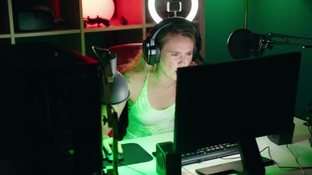 若い美しいパニック女性ストリーマーは ゲームルームでコンピュータを使用して強調 — ストック動画