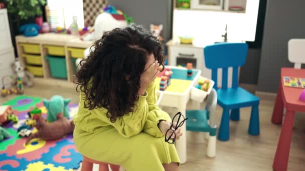 Middle Age Hispanic Woman Preschool Teacher Stressed Sitting Chair Kindergarten — Stock Video