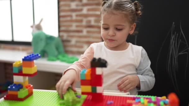 Adorable Hispanic Girl Playing Construction Blocks Standing Kindergarten — 图库视频影像