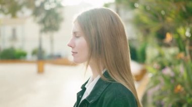 Young caucasian woman smiling confident standing at park