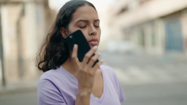 若いアフリカ系アメリカ人女性が路上で心配そうな表情でスマートフォンで話している — ストック動画