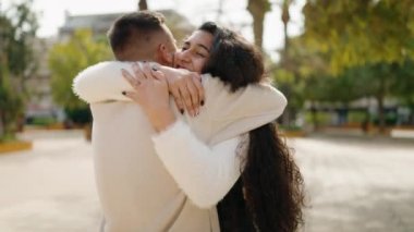 Young couple smiling confident hugging each other standing at park