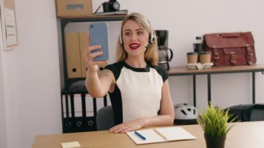 Young beautiful hispanic woman call center agent having video call at office