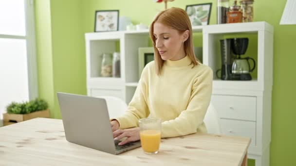 Young Blonde Woman Using Laptop Having Breakfast Home — стоковое видео