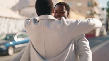 African american couple hugging each other surprise with anniversary gift at street