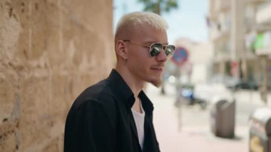 Young caucasian man smiling confident standing at street