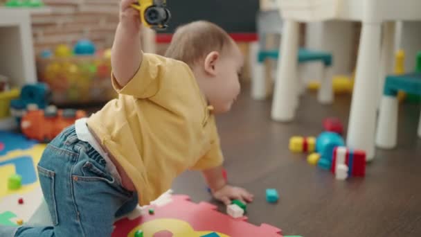 Adorable Hispanic Baby Playing Car Toy Sitting Floor Kindergarten — Stock video