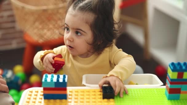Adorable Hispanic Girl Playing Construction Blocks Standing Kindergarten — Vídeo de Stock