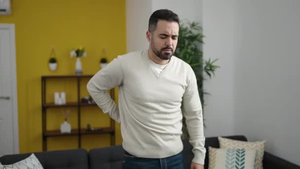 Young Hispanic Man Suffering Backache Sitting Sofa Home — Stock Video