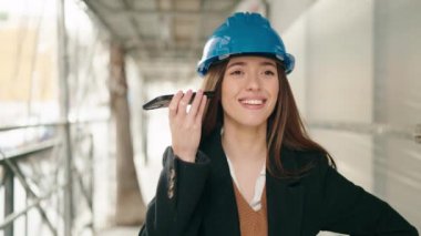 Genç İspanyol kadın mimar. Caddedeki akıllı telefondan sesli mesaj dinliyor.