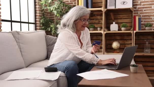 Middle Age Grey Haired Woman Doing Accounting Using Laptop Calculator — Stock video
