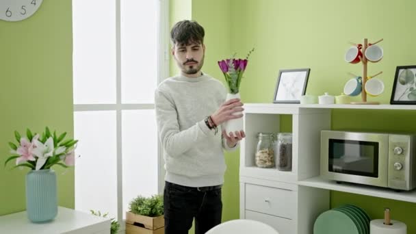 Young Hispanic Man Putting Flowers Vase Dinning Room — Stock Video