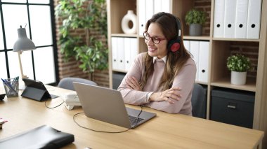 Young beautiful hispanic woman call center agent smiling confident working at office